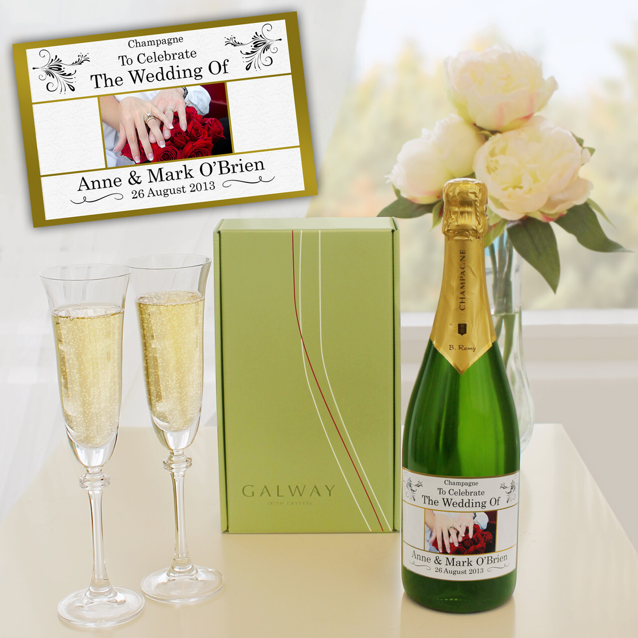 Personalised wedding champagne bottle with custom label, Galway crystal flutes, and floral decor &ndash; elegant gift set for newlyweds and wedding celebrations.