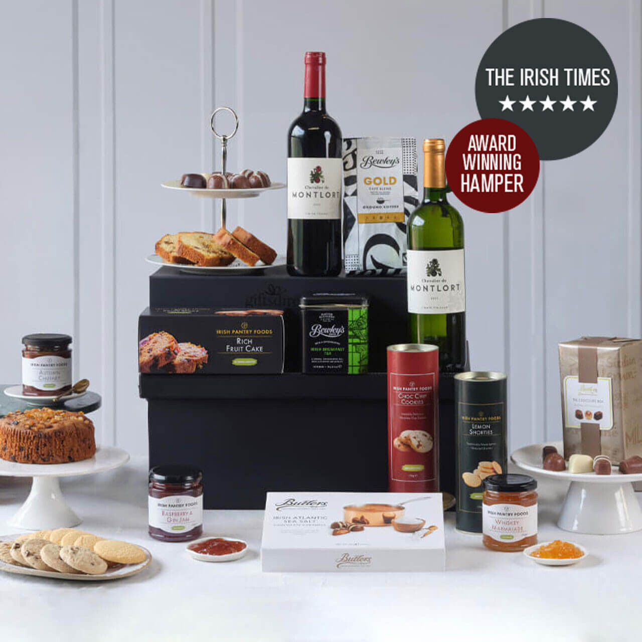 The Classical 5 Star Irish Food Hamper featuring premium wines, traditional Christmas pudding, gourmet biscuits, chocolates, preserves, and festive treats beautifully arranged with holiday decorations &ndash; available at GiftsDirect.com