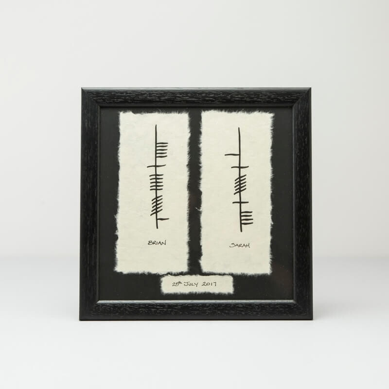 Personalised Ogham Framed Wedding Plaque: A framed piece of Ogham writing on textured white backgrounds. The frame is simple and black, emphasizing the minimalist design.